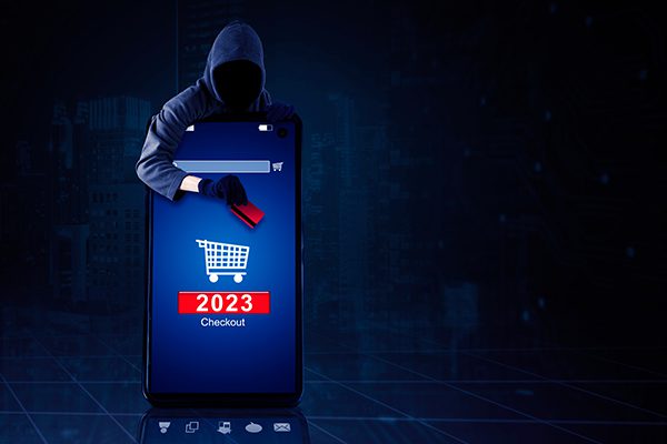 mobile phone with hooded person hovering over with credit card