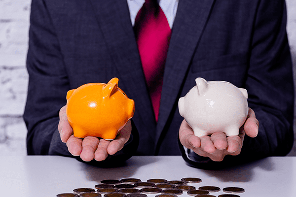 person with two different piggy banks in hand