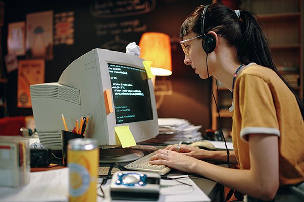 woman on old big desktop pc