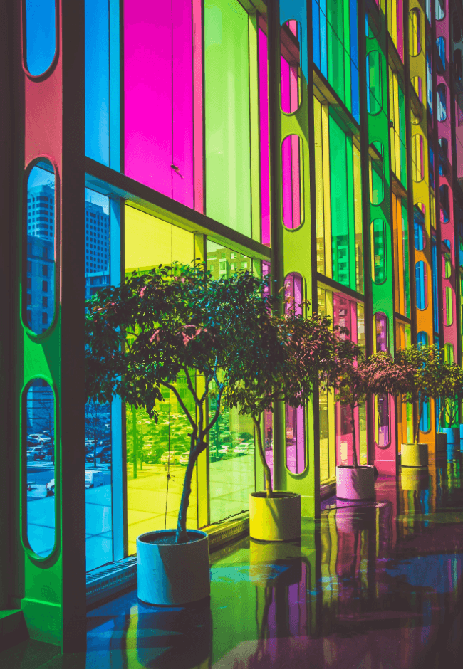 Image of an illuminated multicoloured-glass building facade