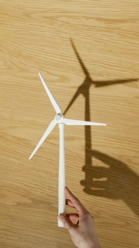 Hand holding small wind turbine